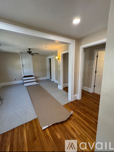 A room with wooden floors and a ceiling fan.