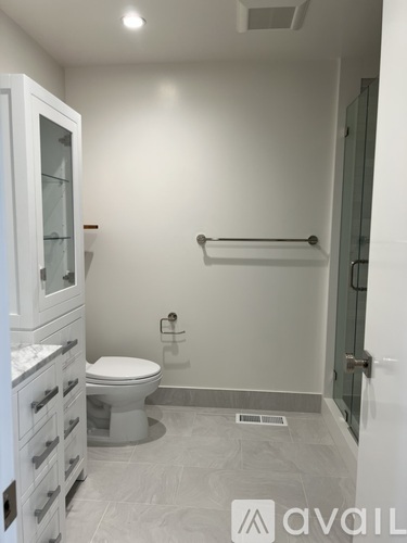 A bathroom with a toilet, sink, and shower.