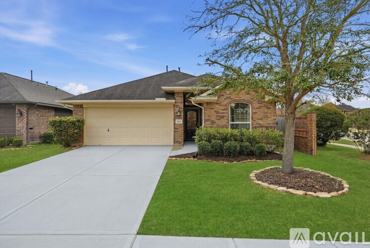A house with a tree in the front yard.