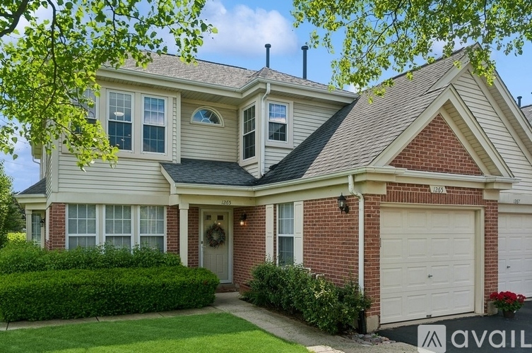 A house with a red brick chimney and a white garage door.
