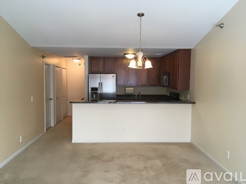 A kitchen with a white counter and brown cabinets.