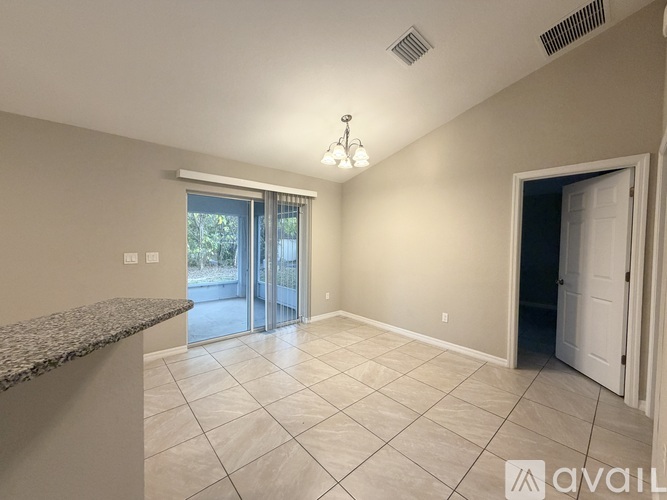 A spacious room with a marble countertop and tiled floor.