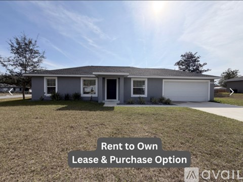 A house with a sign that says "Rent to Own Lease & Purchase Option".