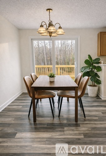 A dining room with a table and chairs.