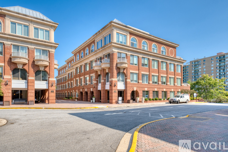A street view of a red brick building with a clear blue sky in the background.
