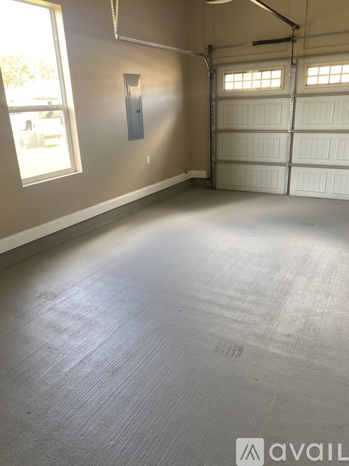 A spacious garage with a white door and a window.