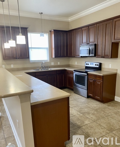A kitchen with brown cabinets and a white island.