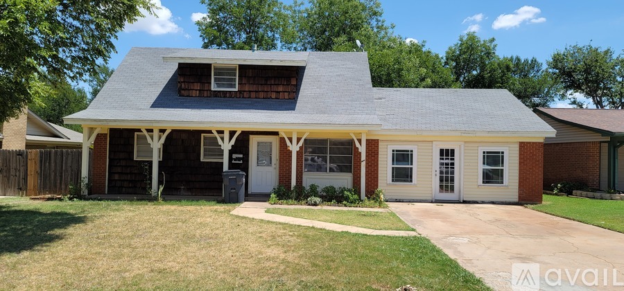 A house with a garage and a covered porch is for sale.
