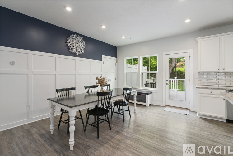 A dining room with a table set for four.