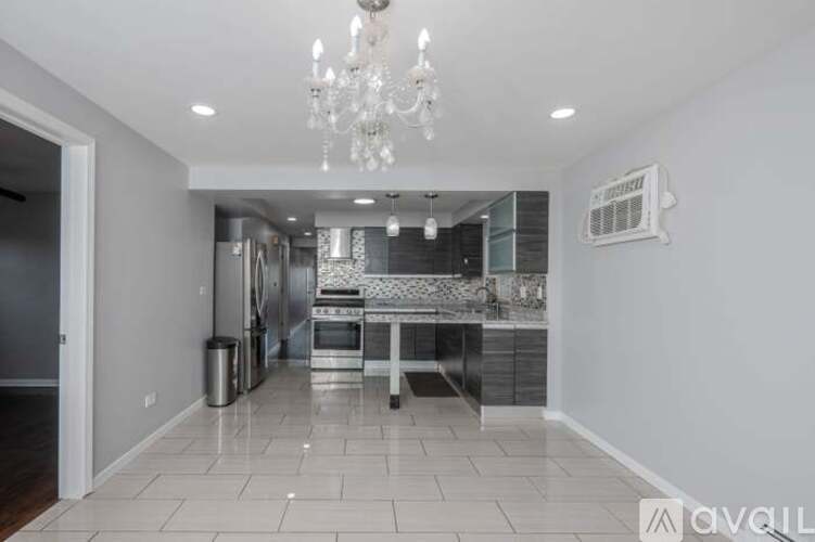 A spacious kitchen with a dining table and chairs.