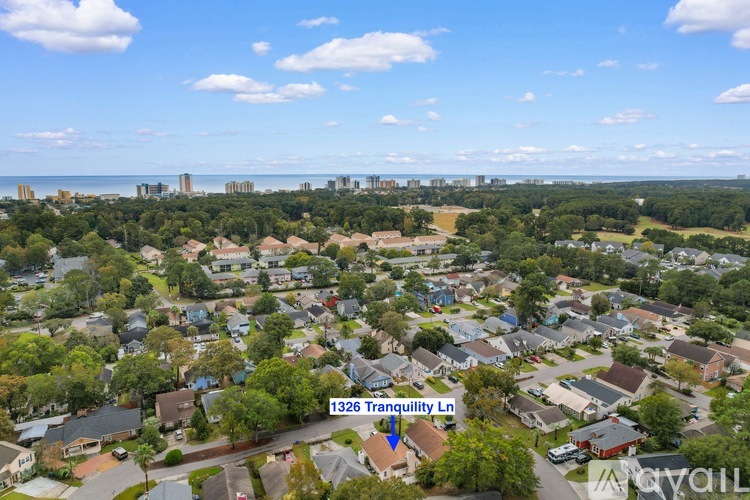 A bird's eye view of a residential area with houses and trees.