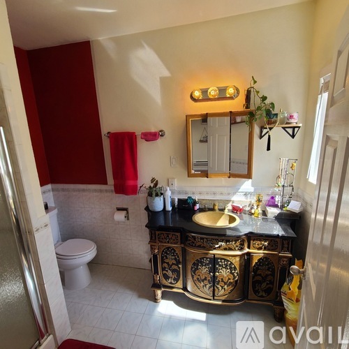 A bathroom with a red towel hanging on the wall.