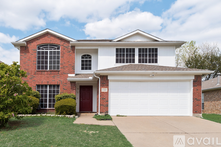 A house with a red door and a white garage door.