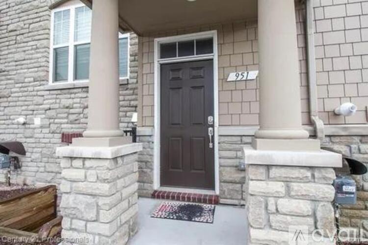 A house with a black door and a number 951 on the wall.