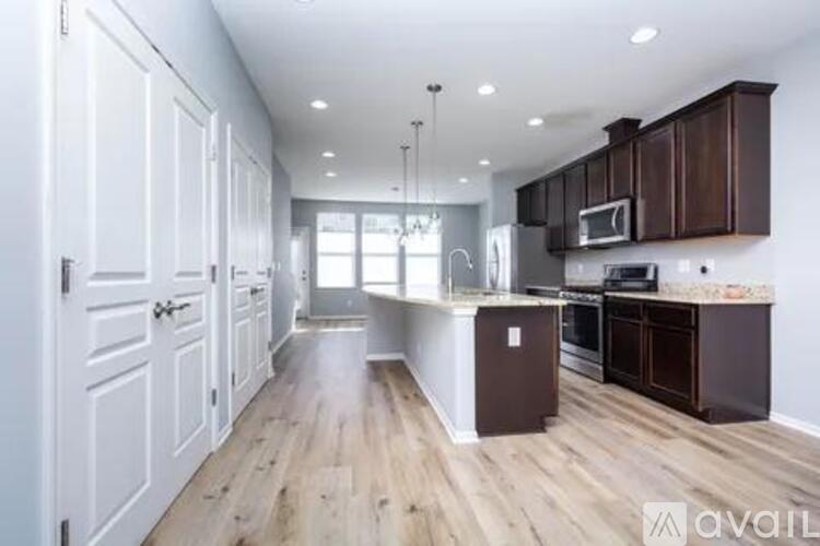 A kitchen with wooden floors and white walls.