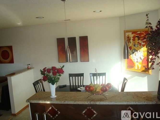 A dining room with a granite table and chairs.