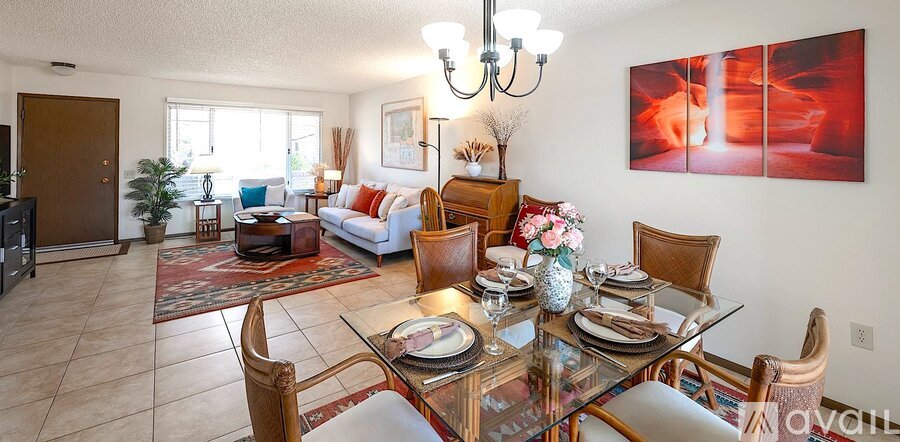 A dining room with a glass table and chairs.