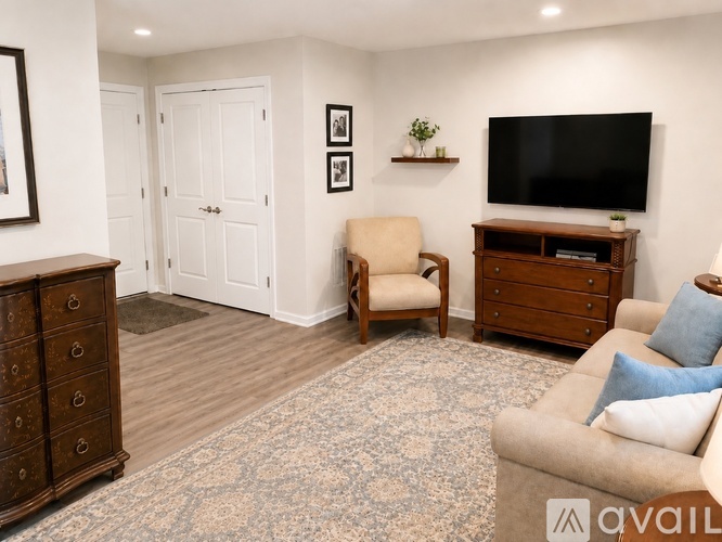 A living room with a stationary bike in the corner.