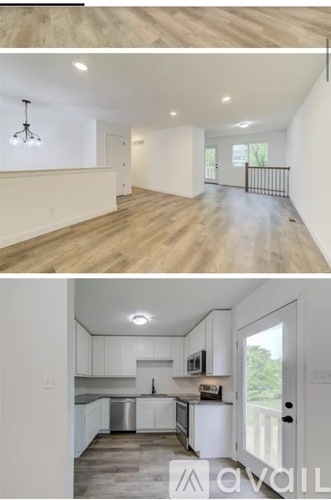 A modern kitchen with white cabinets and a wooden floor.