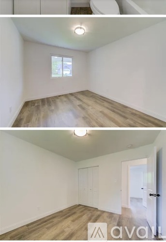 A room with wooden floors and white walls, with a window and a door visible.