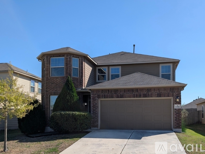A house with a garage and a driveway is for sale.