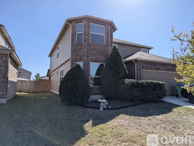 A house with a brown brick exterior and a well-maintained lawn.