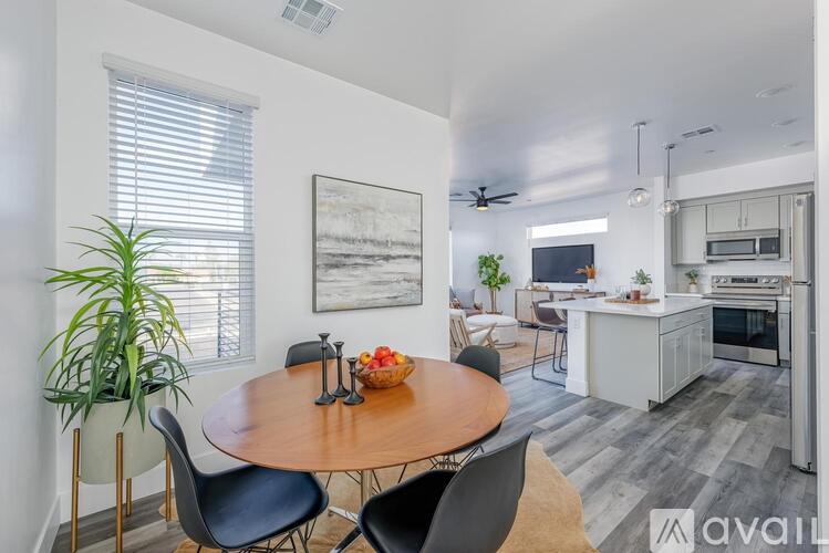A modern kitchen with a dining table and chairs.