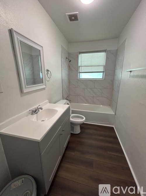 A bathroom with a toilet, sink, and bathtub.