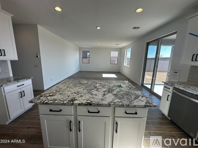 A kitchen with granite countertops and white cabinets is available for rent.