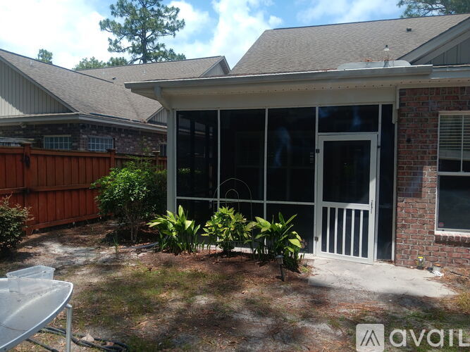 A house with a patio and a white fence.