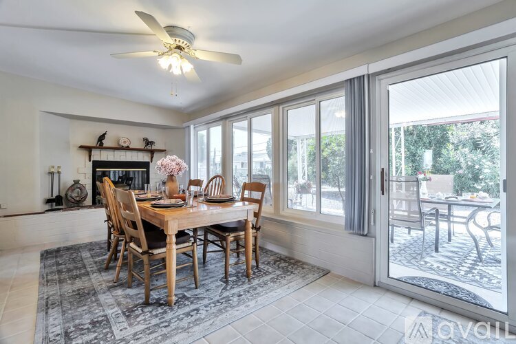 A dining room with a table set for six.