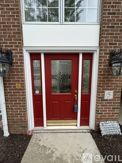 A red door with a glass window and a white frame.