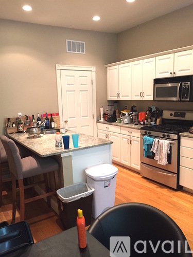 A kitchen with a table and chairs in it.