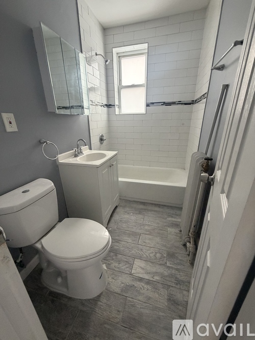 A bathroom with a toilet, sink, and tub.