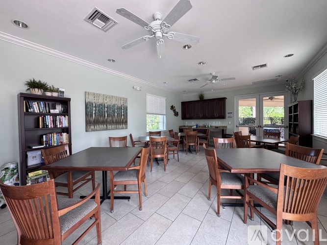 A dining room with a large table and chairs.