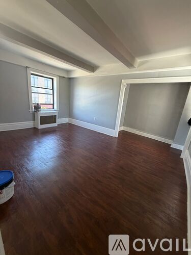 A room with wooden floors and a window.