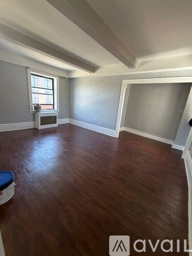 A room with wooden floors and a window.