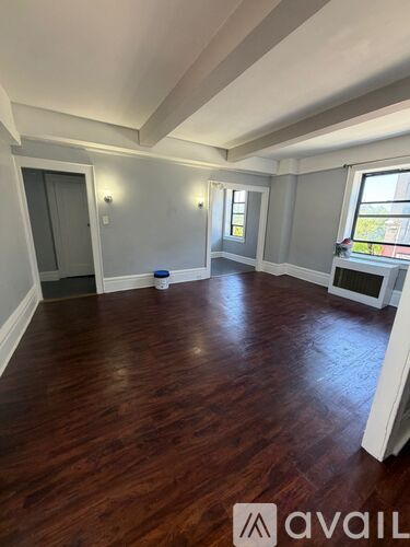 A room with wooden floors and white walls.
