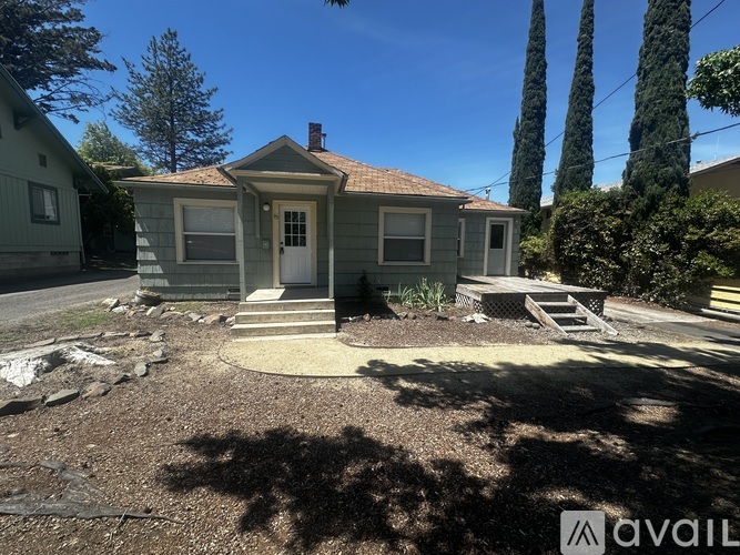 A house with a front yard and a driveway.