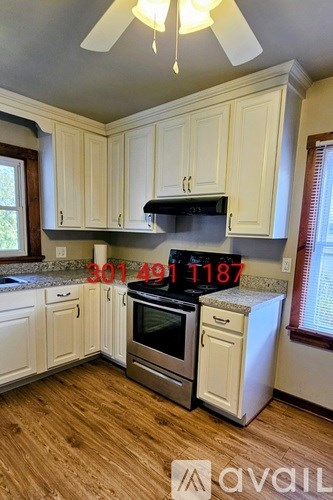A kitchen with wooden cabinets and a stainless steel oven.