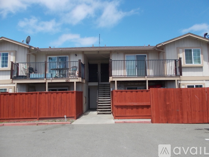 A two-story house with a balcony on the second floor.
