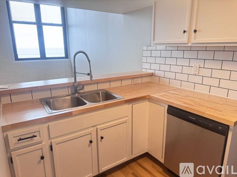 A kitchen with a sink and a window.