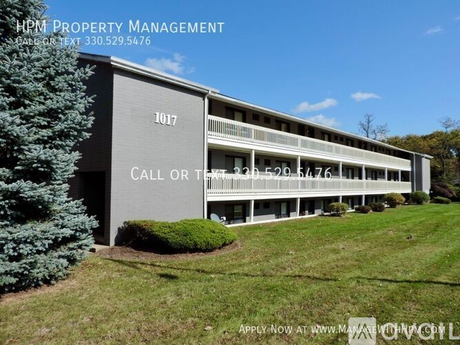 A building with the number 1017 on it and a sign that says "Call or Text 330.529.5476".