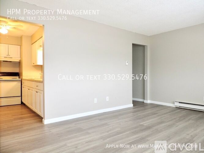 A room with a kitchen area and a text that says "HPM Property Management".