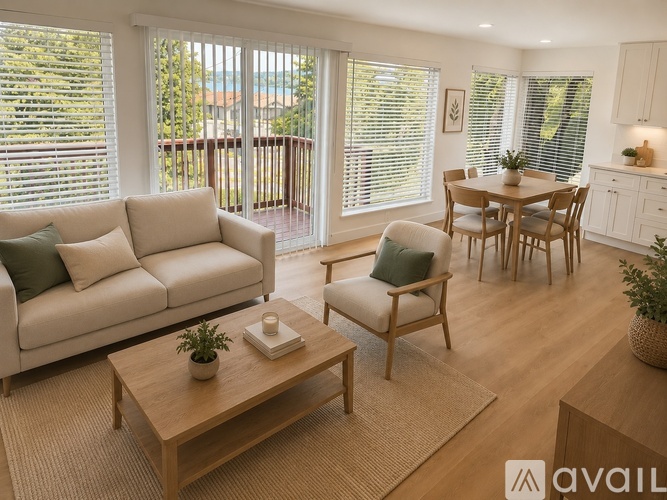 A kitchen with white cabinets and wooden floors.