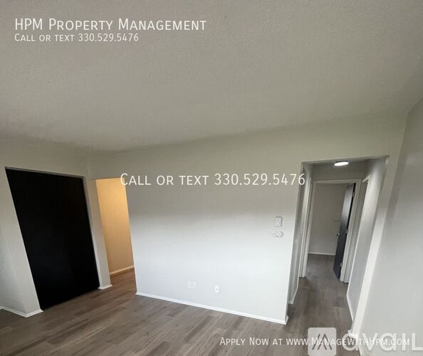 A room with a sign that says HPM Property Management and a phone number.