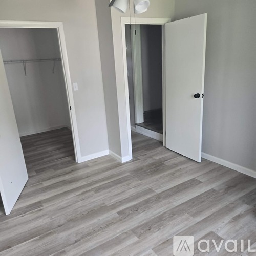 A room with a white door and a white wardrobe.
