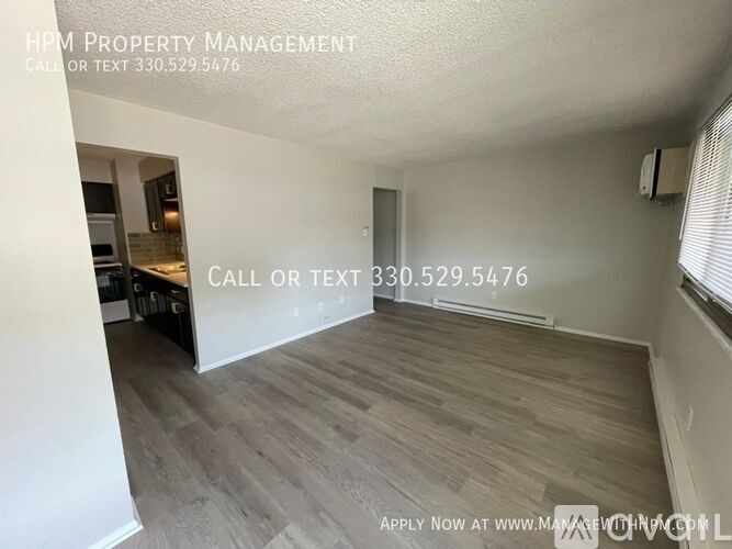 A room with a kitchen area and a dining table is available for rent.