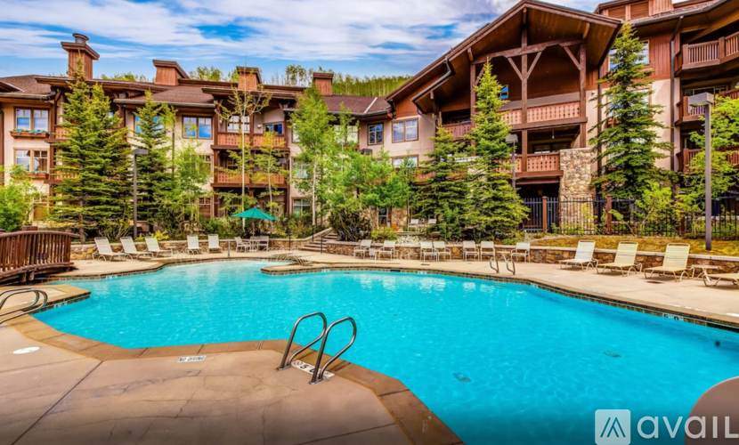 A large swimming pool in front of a resort.