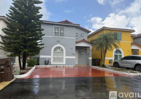 A house with a grey and yellow exterior is available for sale.